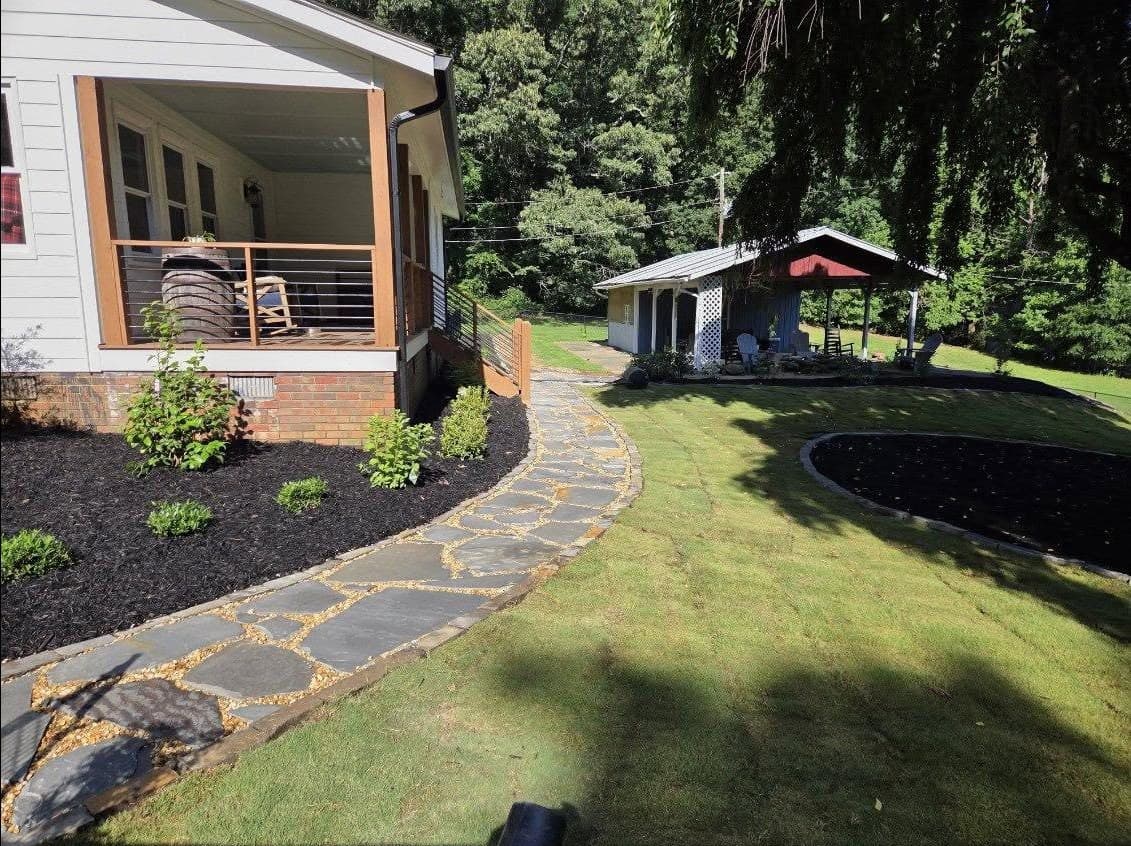 Flagstone stepping-stone walkway with fresh mulch beds
