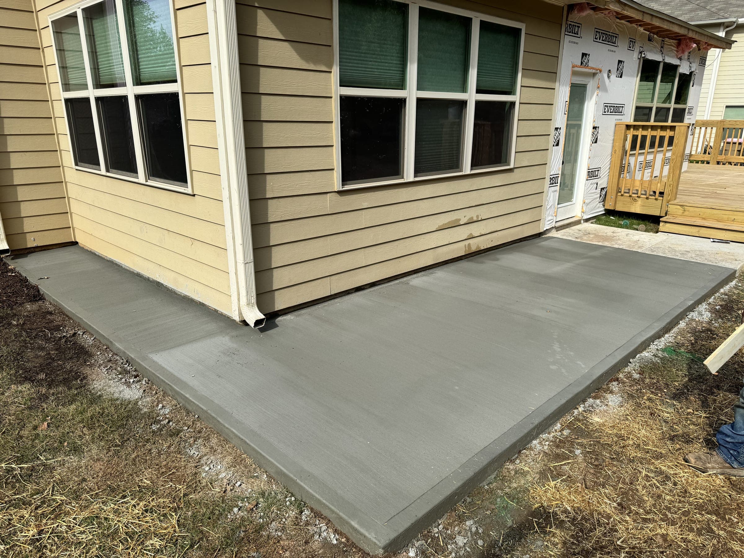 Freshly poured concrete slab at a home's back entry