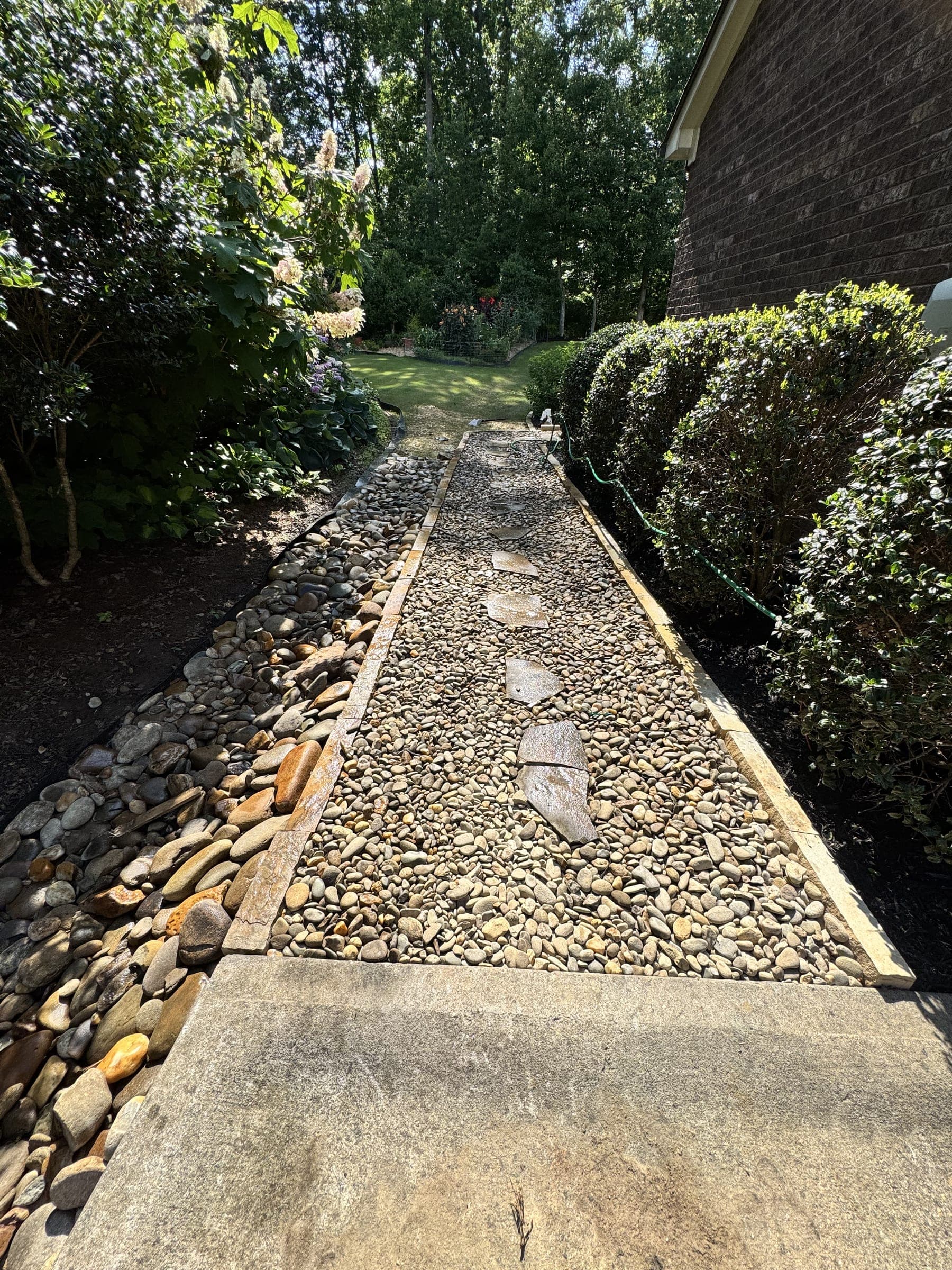 Gravel-lined drainage swale alongside a home
