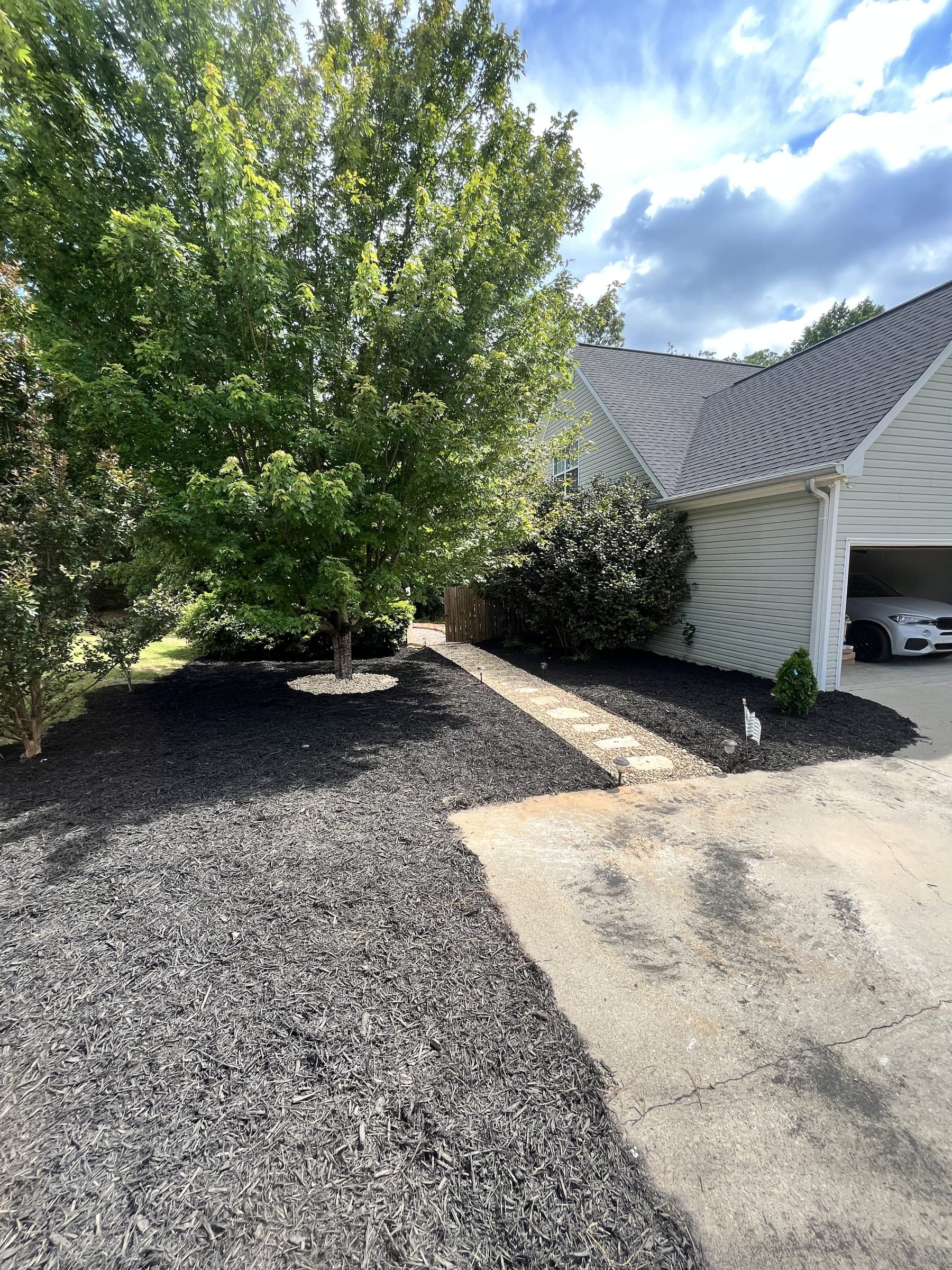 New concrete driveway apron beside a garage