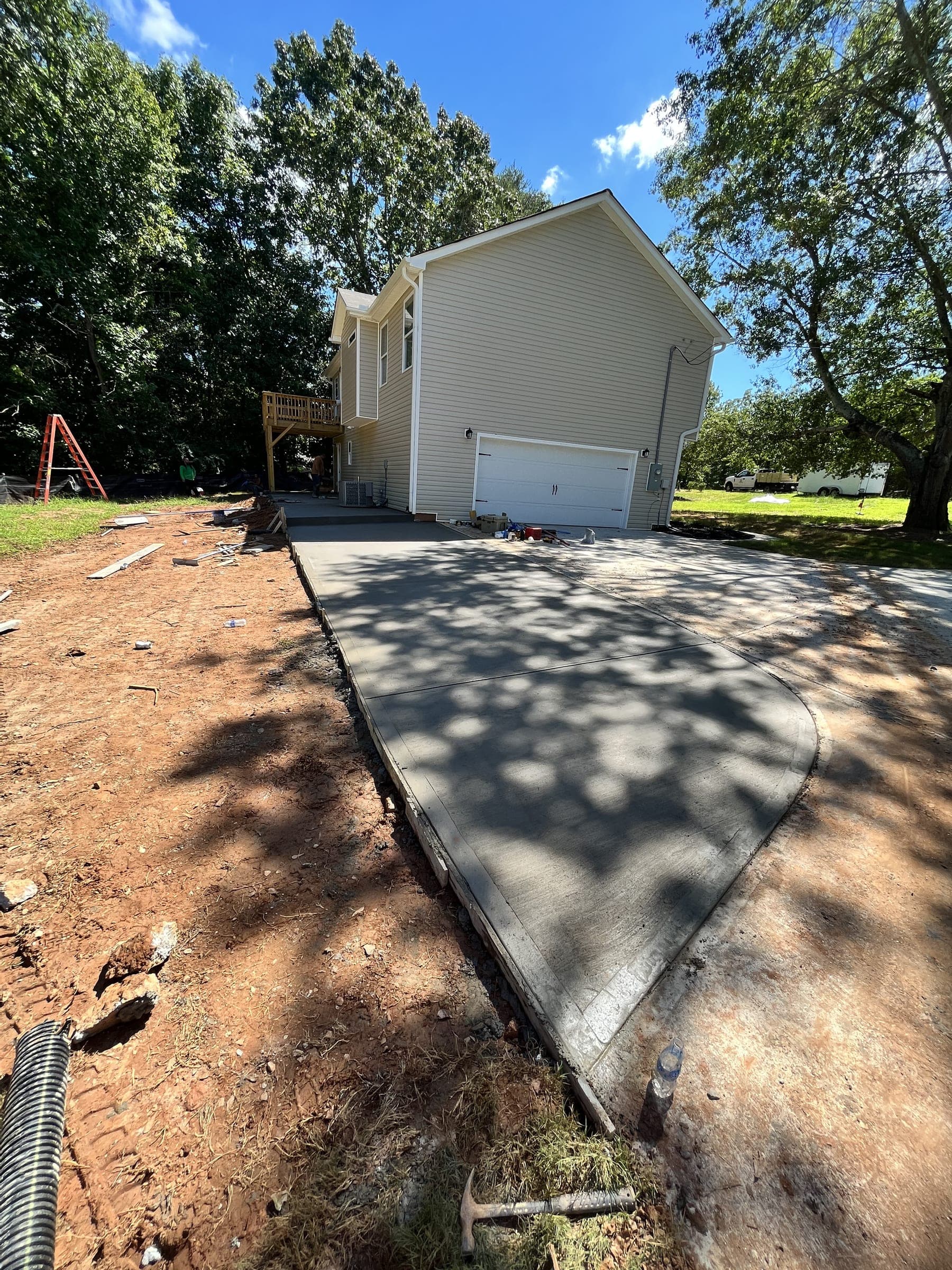 New concrete driveway leading to a detached garage