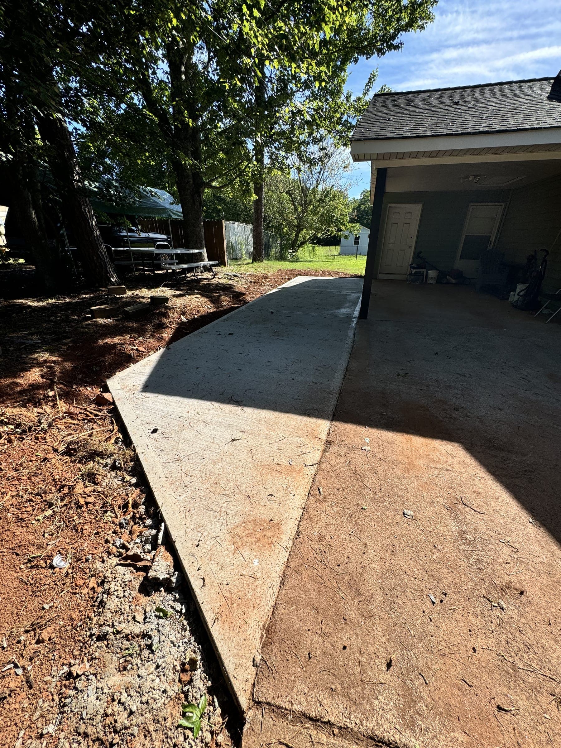 New concrete walkway along the side of a home