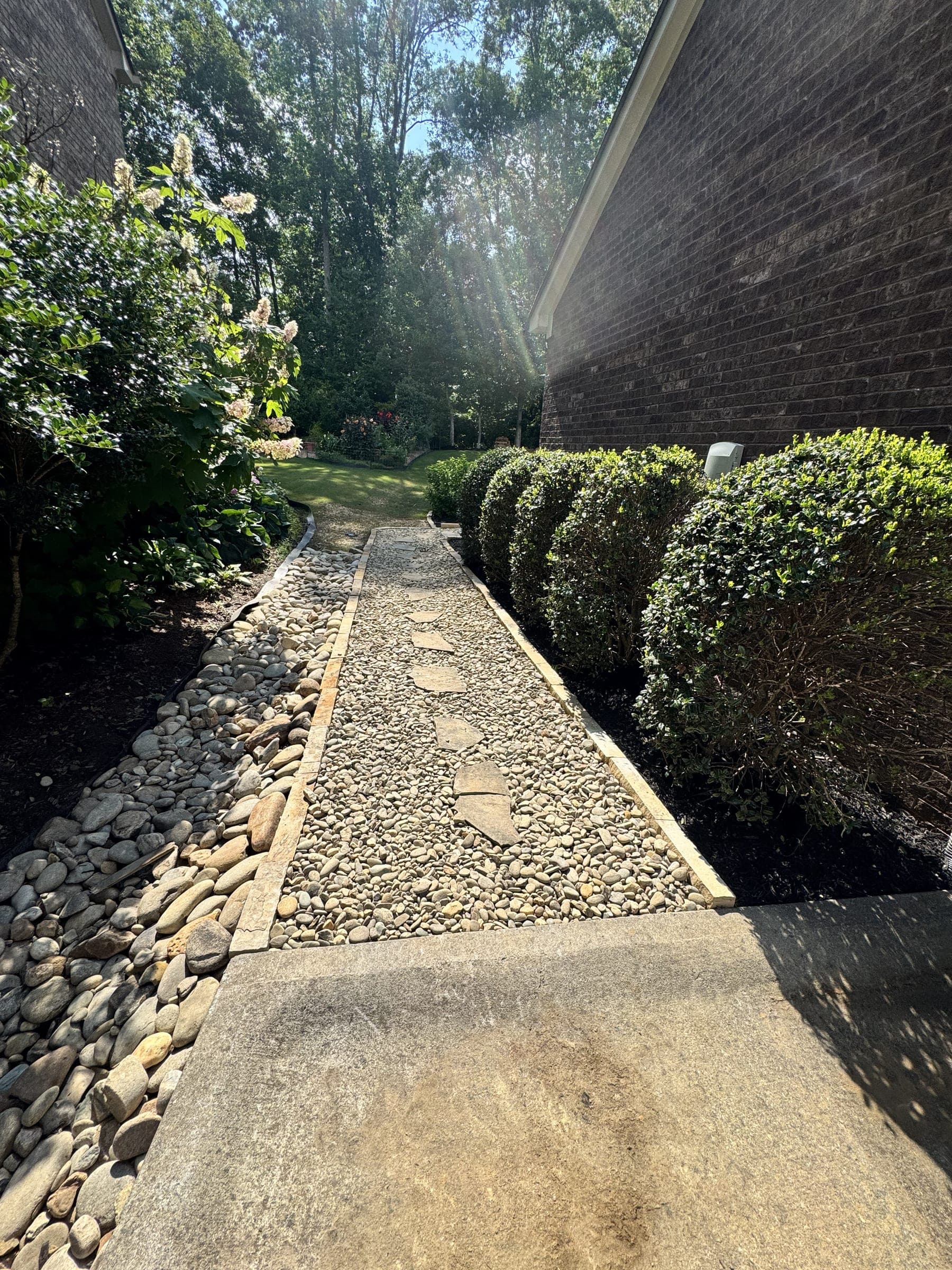 Drainage rock and a concrete walk along a home's foundation