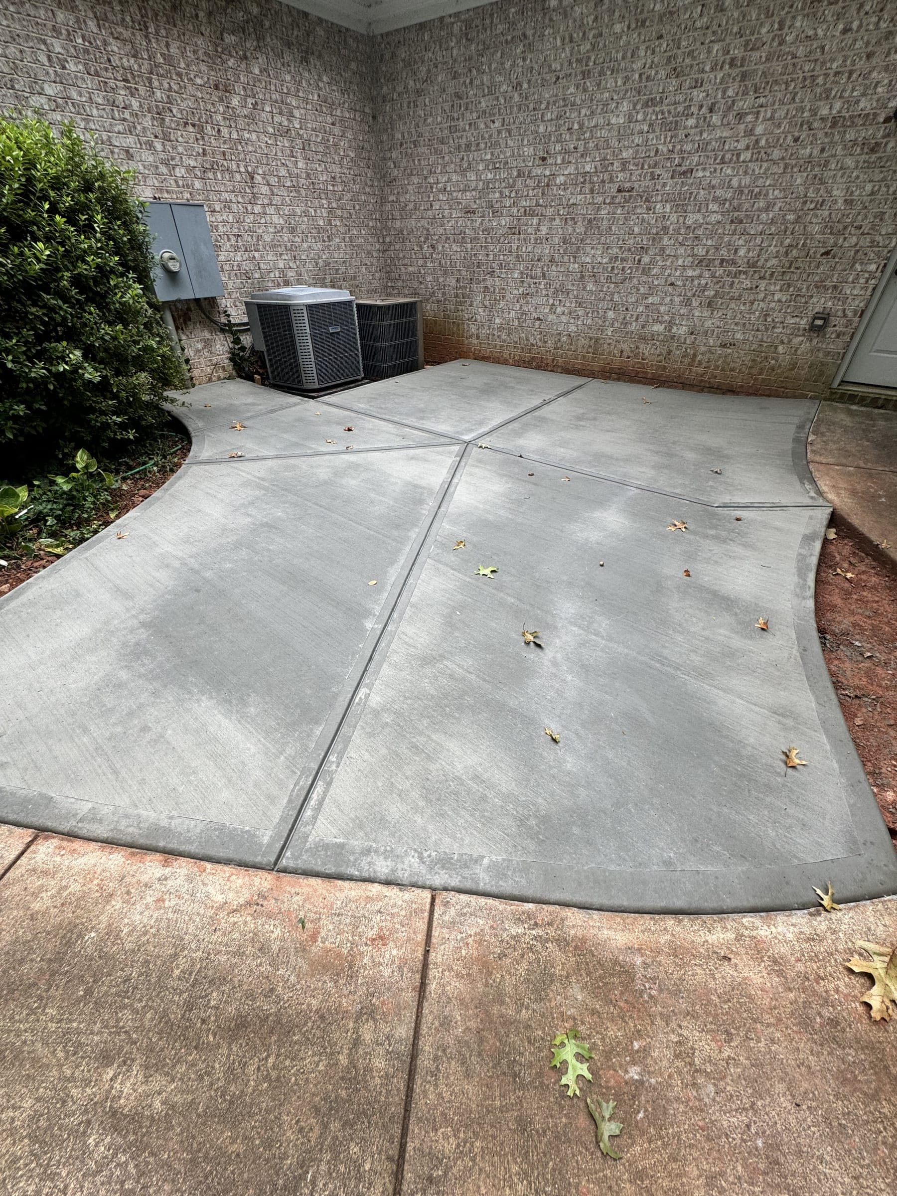 New concrete patio outside a home's back doors